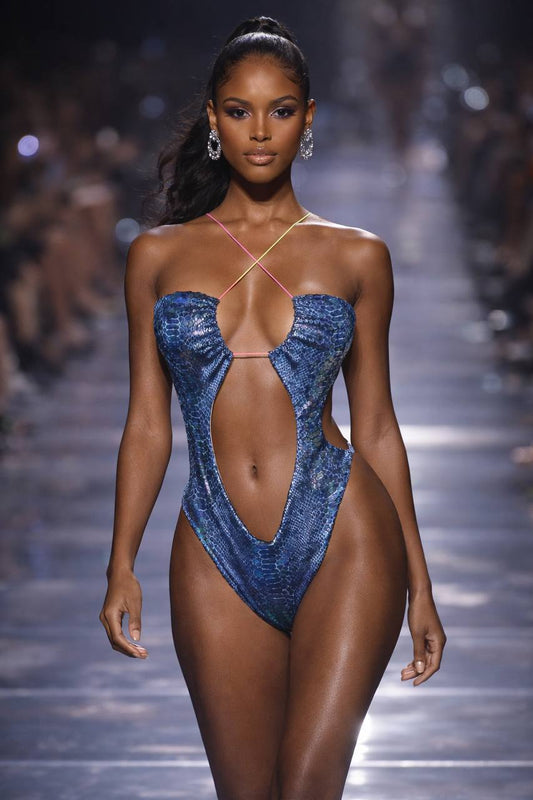 Metallic blue velvet one‑piece swimsuit with a sculpted silhouette and luxe high‑shine finish for modern beach and resort styling